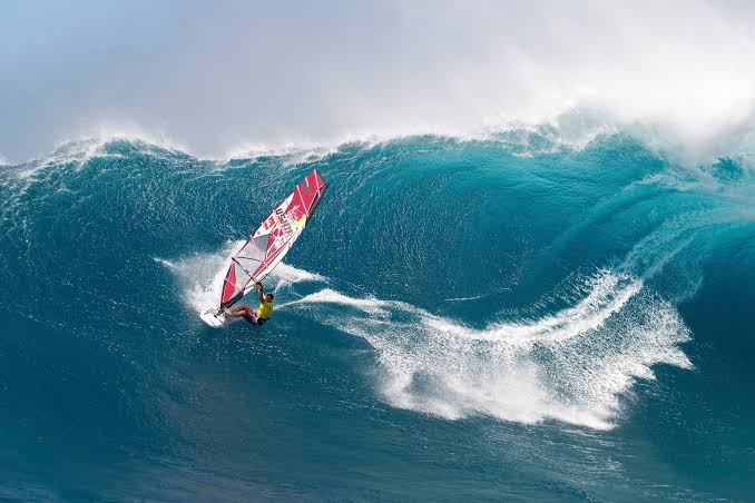 Robby Naish: "1976, Flat Island, Kailua Bay, Oahu, Hawaii. Original  windsurfer... footstraps not invented yet, but still able to jump and get  the fin out of the water. Wooden booms with harness