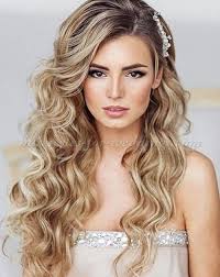 A messy side low bun, with messy volumes and some locks down. Hair Down Bridesmaids Hairstyles