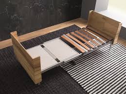 It has a smooth, gray laminate top and black metal, open frame legs. Coffee Table Convertible Into A Bed Or A Dining Table Idfdesign