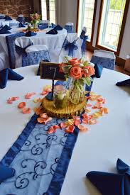 We wrapped fairy lights around the beams, hired giant love letters. Wood With Glass Coral Roses And Lambs Ear Centerpiece With Navy Blue Table Runners Coral Wedding Decorations Blue Wedding Decorations Navy Wedding Centerpieces