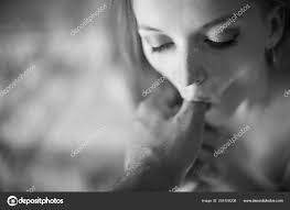 A young girl erotically licks and sucks the finger of a mans hand and looks  into his eyes. Imitates oral sex Stock Photo by ©inside-studio 254108208