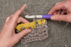 These combinations are connected by 'tweener strands. Hands Knitting Thick Wool Using A Large Crochet Needle Stock Photo Picture And Royalty Free Image Image 73620853