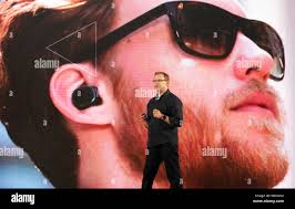Steve Sinclair, Vice President of product management of Motorola Mobility,  introduces the Moto Hint bluetooth headset at the launch ceremony for the M  Stock Photo