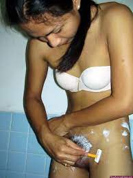 Thai t-girl shaving and trimming the body hairs around her cock