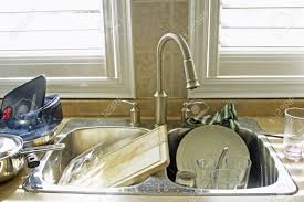 kitchen sink and dirty dishes stock