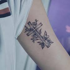 If you like traditional cross tattoos and would like to uses some roses in your design, then why not think about something like this one here? 50 Beautiful Cross Tattoos To Showcase Your Faith Inspirationfeed