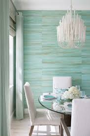 The mint green walls lighten up the intense emerald green pieces and bold black and white carpet, while the blue side table keeps things interesting. Dining Room With Turquoise Seagrass Wallcovering Coastal Dining Room Decor Coastal Dining Room Turquoise Living Room Decor