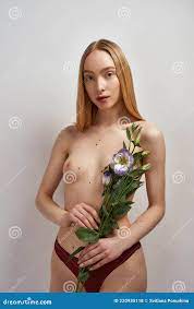 Creative Shot of Beautiful Young Woman with Naked Breast Holding Eustoma  Flowers Over Gray Background Stock Photo - Image of lingerie, background:  220935118