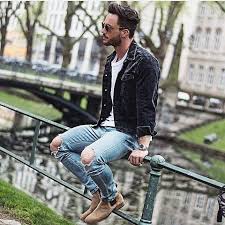Leather shearling jacket, white print tee, dark ripped jeans, and brown chelsea boots. Men S Black Denim Jacket White Crew Neck T Shirt Light Blue Ripped Skinny Jeans Tan Suede Chelsea Boots Black Denim Jacket Outfit Denim Jacket Men Black Denim Jacket