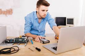 A computer repair technician is a person who repairs and maintains computers and servers. Technician Repairing A Desktop Computer Using Laptop Stockphoto