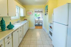 Yellow And White Kitchen In A Cozy Tacoma Wa Craftsman Tile Floors And Lots Of Window Light Yellowandwhitekit Craftsman Kitchen Yellow Kitchen Real Kitchen