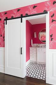 Black And White Barn Door A White Barn Door On Oil Rubbed Bronze Rails Is Partially Framed By Pink And Black Wallpaper Finished With Bathroom Trends Remodel Bedroom Interior Barn Doors