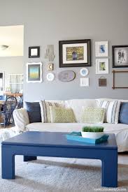 Gold and grey commingle in this living room, where a striking wood wall acts as the divider between the window seat beyond. Inspiring Spaces Beautiful Grey Rooms Part 1