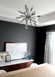 Dark walls inset with beige panels and framed by white moldings bring a sense of drama to the living room. Modern Dark Grey Dining Room Makeover Tag Tibby Design