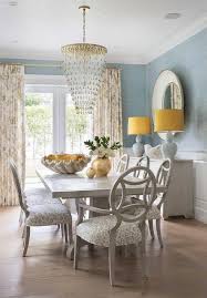 Transitional Dining Room With Wainscoting Walls Features A Gray Wooden Dining Table With Oval Back Dini Interior Design Velvet Dining Chairs Brown Dining Table