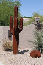 This Decorative Saguaro Cactus And It S Barrel Cactus Companion Are Located Just Outside The Fence Ar Outdoor Cactus Garden Outdoor Cactus Plants Cactus Plants