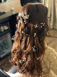 The hair is swept to the side in a pompadour fashion and the medium length locks hang to the side. 17 Trendiest Hairdos To Glam Up Your Wedding Reception Look Shaadisaga
