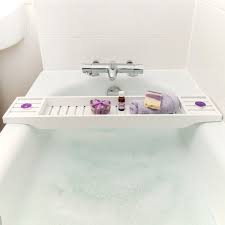 A perforated dish to hold soap or loofahs, a wine glass slot, and hooks for hanging a washcloth or razor. Wooden Bath Rack White Grid Bath Caddy Wooden Bath Tray The Bath Rack