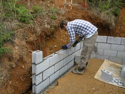 If you want to build a living wall, stack cinder blocks so the holes face upright all along the top edge. Concrete Block Garden Retaining Wall