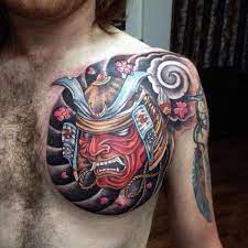 Traditional black ink samurai head tattoo on man right chest. Mens Bold Samurai Mask On Stormy Background Chest Tattoo Ultracooltattoos Samurai Tattoo Design Japanese Tattoos For Men Samurai Mask Tattoo