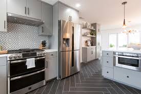 Take A First Look At Christina Anstead S New Show Christina On The Coast Hgtv Mid Century Modern Kitchen White Tile Backsplash Black And White Tiles