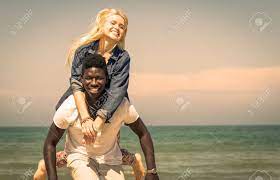 Interracial Couple On The Beach Stock Photo, Picture and Royalty Free  Image. Image 28135610.