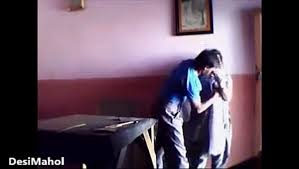 Teacher kissing in class room