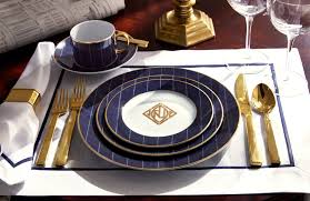The dinner plate is in a bright gold, with a blue floral salad plate and a white napkin held together by a silver napkin ring. How To Set A Table Casual Formal Table Setting Luxdeco