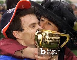 Image of TRAINER SHEILA LAXON KISSES JOCKEY SCOTT SEAMER AFTER WINNING  MELBOURNE CUP