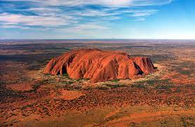 Also known as ayers rock, this sandstone rock is said to be the largest monolith in the world standing at 1142 ft high. Datei Uluru Helicopter View Cropped Jpg Wikipedia