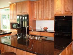 With this colorful but not overpowering combination, your kitchen can offer a bright and inviting bring in color and personality through brick red and black painted cabinetry. Amazing Small Kitchen Designs With Black Appliances Cabinet Color Ideas Algarve Laurelinekoenig