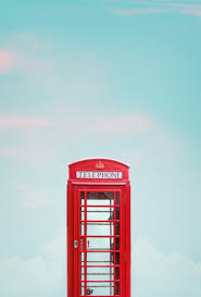A small enclosure containing a public telephone. Photo Of Red Telephone Booth Under Blue Sky Free Stock Photo