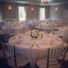 The Silver Chiavari Chairs With The White Linens Add Such An Elegant Touch To This Weddi Wedding Reception Chairs Wedding Table Settings Silver Chiavari Chairs