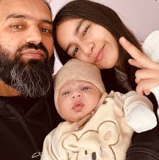 A portrait photographer sits next to his homemade camera