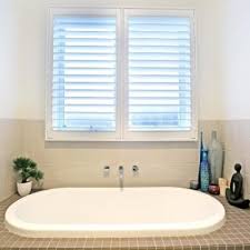 This bay window has used natural wood shutters to contrast in the mainly white design. Into Blinds Into Blinds