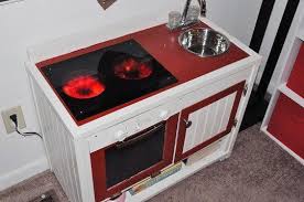 The stove top burners are actually cd discs with led lights attached. Play Kitchen With Dimmable Burners Diy Play Kitchen Play Kitchen Kids Play Kitchen