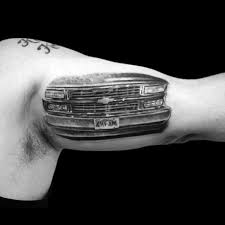 Flaming chevy logo and rally flags tattoo on half sleeve. 60 Chevy Tattoos For Men Cool Chevrolet Design Ideas