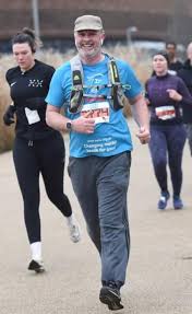 Why is David running a 10K every month for charity?