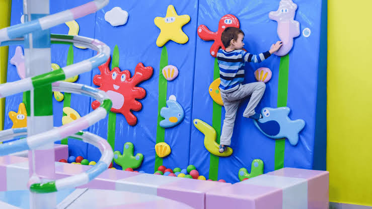 Child climbing indoor wall