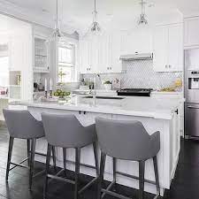 Bar stools can complement a kitchen island table, but they can be uncomfortable and can look out of place if they are too big or too small in. White Island With Gray Leather Bar Stools Bar Stools Kitchen Island White Kitchen Stools Home Decor Kitchen