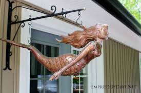 This delightful resin piece is shaped like a mermaid with the look of carved and weathered wood. 24 Creative Garden Fence Ideas