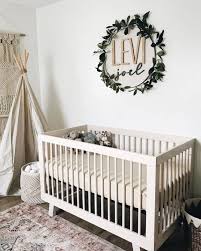 Nursery Decor Idea With The Name Placed On The Wall And Accented With A Fake Greenery Wreath Boho Baby Room Nursery Baby Room Baby Room Decor