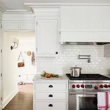 They have a subtle crackle appearance within the glaze, with a smooth and glossy surface. White Glazed Mini Subway Tile Backsplash Design Ideas