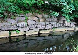 Maybe you would like to learn more about one of these? Stone Retaining Wall Alongside The River Bank Reflection Of Wall And Trees In The Calm Water Of The River Stock Photo Alamy