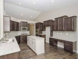 It's a fantastic color scheme that creates a beautiful and dramatic new kitchen with black cabinets throughout with light beige and dark brown granite. Gourmet Kitchen Radford Maple Flagstone Perimeter Cabinets Lillian Purestyle Glacier Gra Marble Floor Kitchen Kitchen Cabinets White Shaker Kitchen Cabinets