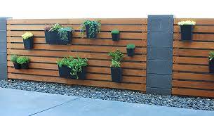 Wooden slats coated with wall headboard of the bed are a very attractive way. Remodelaholic Diy Wood Slat Garden Wall With Planters