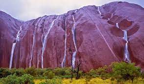 Uluru/ayers rock, giant monolith, one of the tors (isolated masses of weathered rock) in southwestern northern territory, central australia. Rare Uluru Waterfalls Spotted In Australia Places To See In Your Lifetime