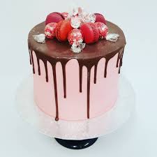 Smooth Light Pink Drip Cake With Macarons And Lindt Balls Lindt Cake Drip Cakes Chocolate Topping