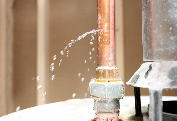 Plumber repairing a residential pipe during an urgent plumbing service call in Griffin, GA