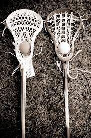 Two Lacrosse Heads And Sticks With Ball On Grass Black And White Lacrosse Youth Lacrosse Lacrosse Coach